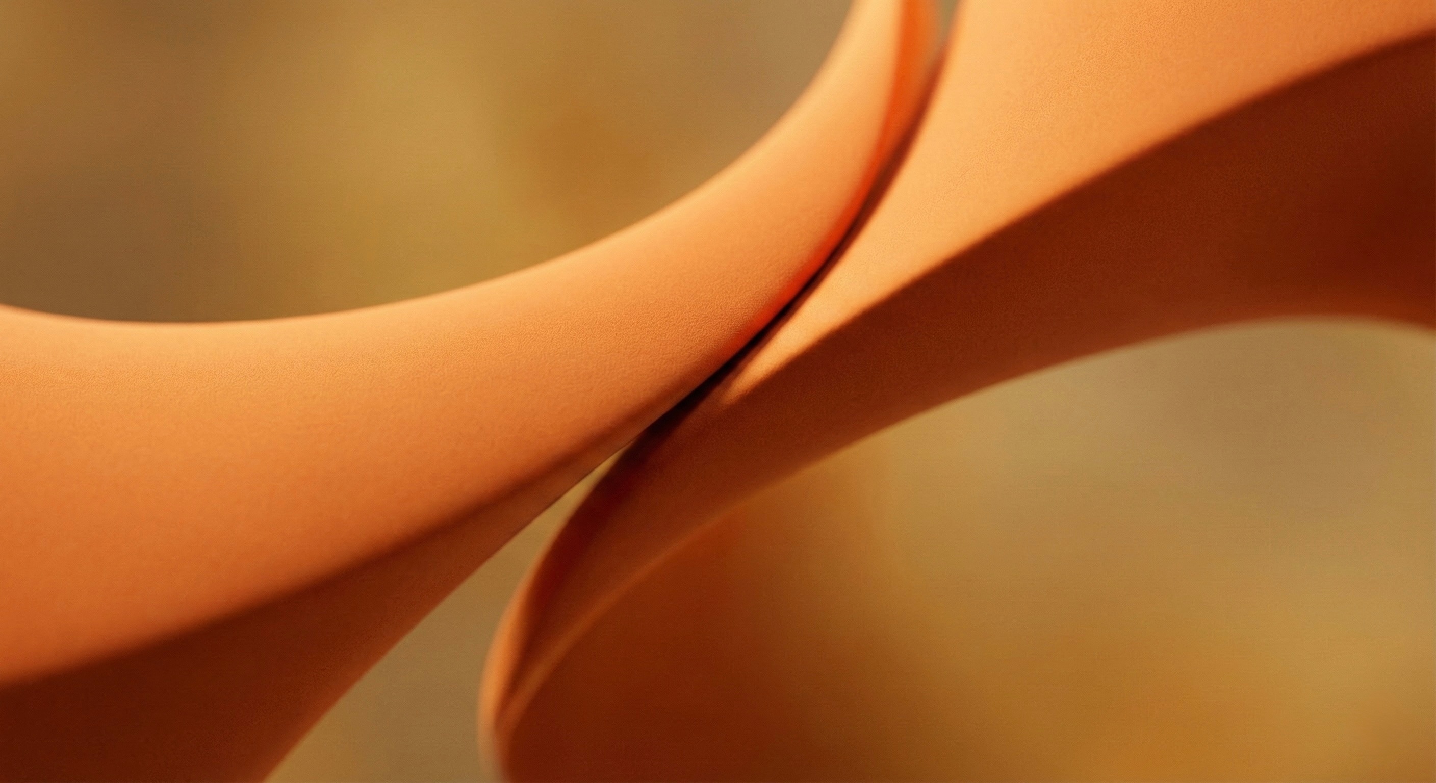 Close-up of a rounded corner of a brown leather phone case with textured surface.