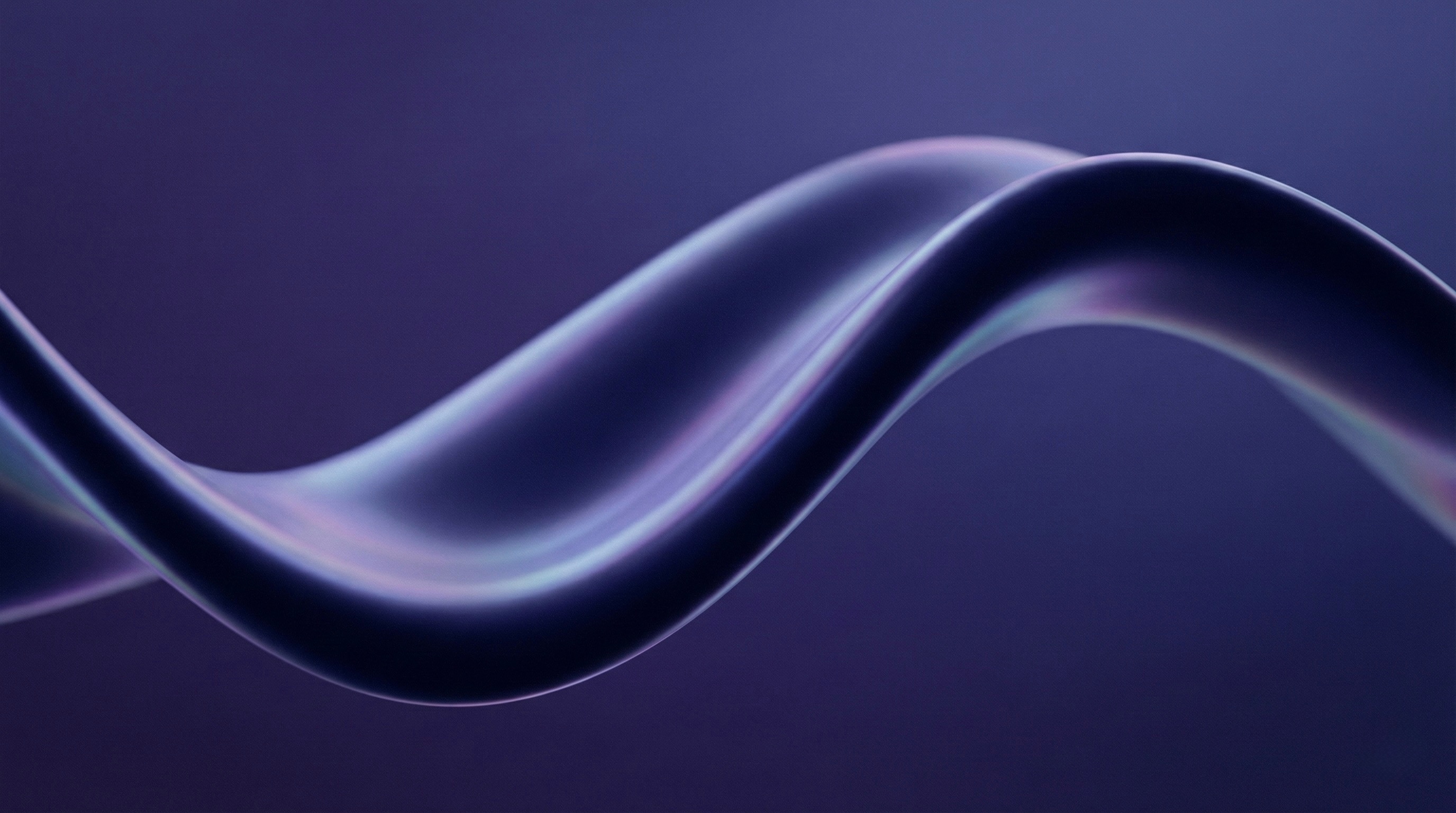 Close-up of a corner of a tablet with a smooth glass screen and rounded edges on a purple surface.